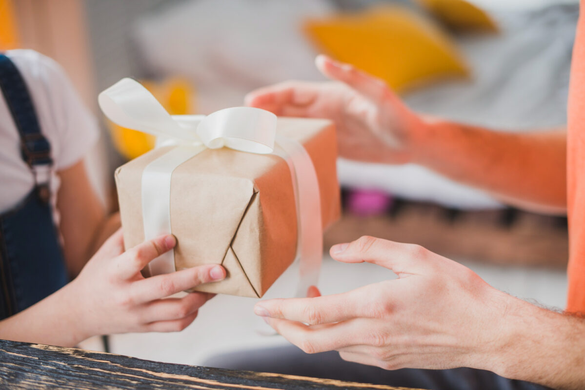 fathers day concept with daughter giving gift